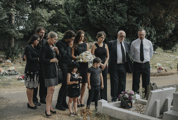 Family mourning a loved one at the graveside