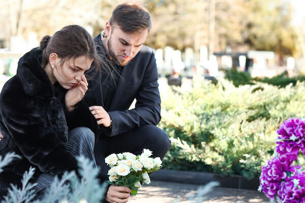 Couple visiting grave of loved one 